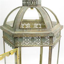 Pair of patinated brushed brass lanterns, of domed hexagonal form, with pierced gallery and swing handle, H63cm 