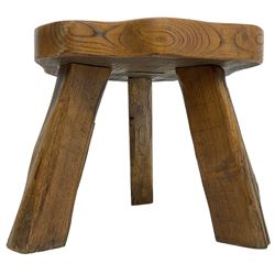 Small rustic elm three-legged stool, with metal plaque to the underneath inscribed 'Wandewood' 