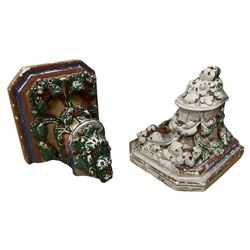 Two Victorian polychromed plaster cast corbels or wall brackets, canted rectangular tops over moulded edge and curled fruiting foliage