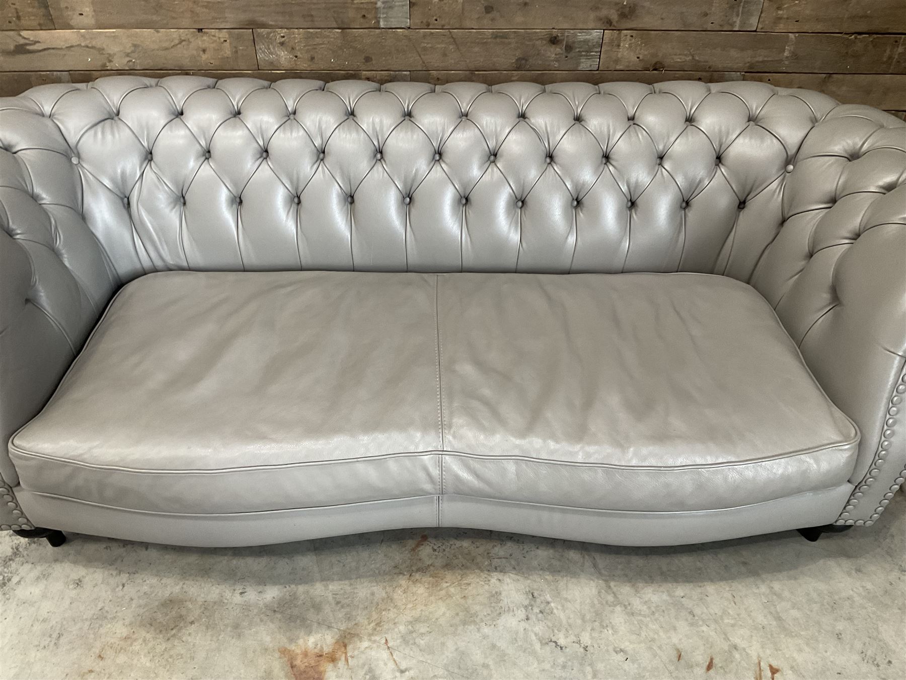 Three seat Chesterfield sofa, upholstered in grey buttoned leather