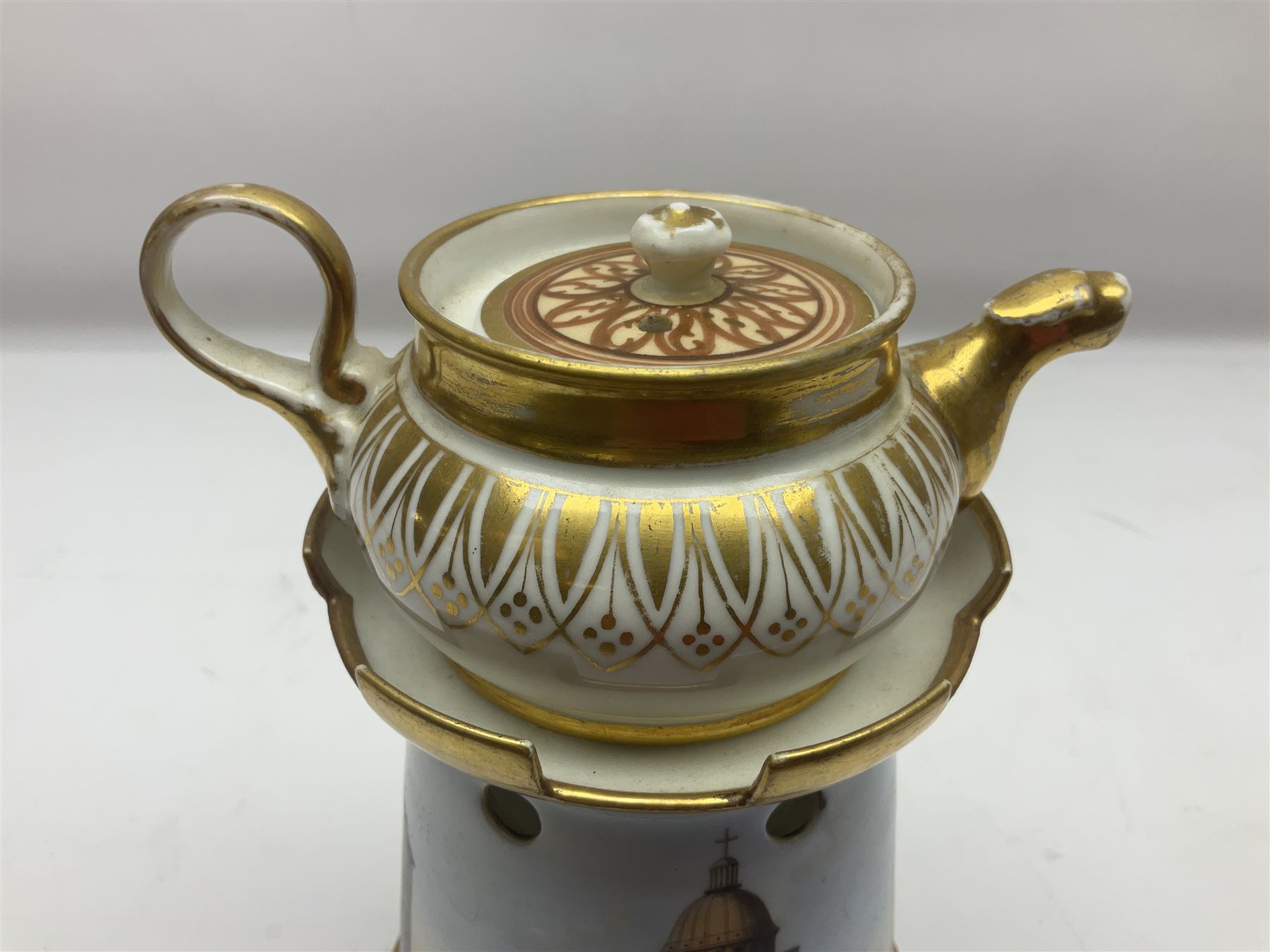 19th century continental teapot and warmer, the teapot upon a cylindrical warming base in the form of a castle, hand printed with 'Le Pantheon', H21cm