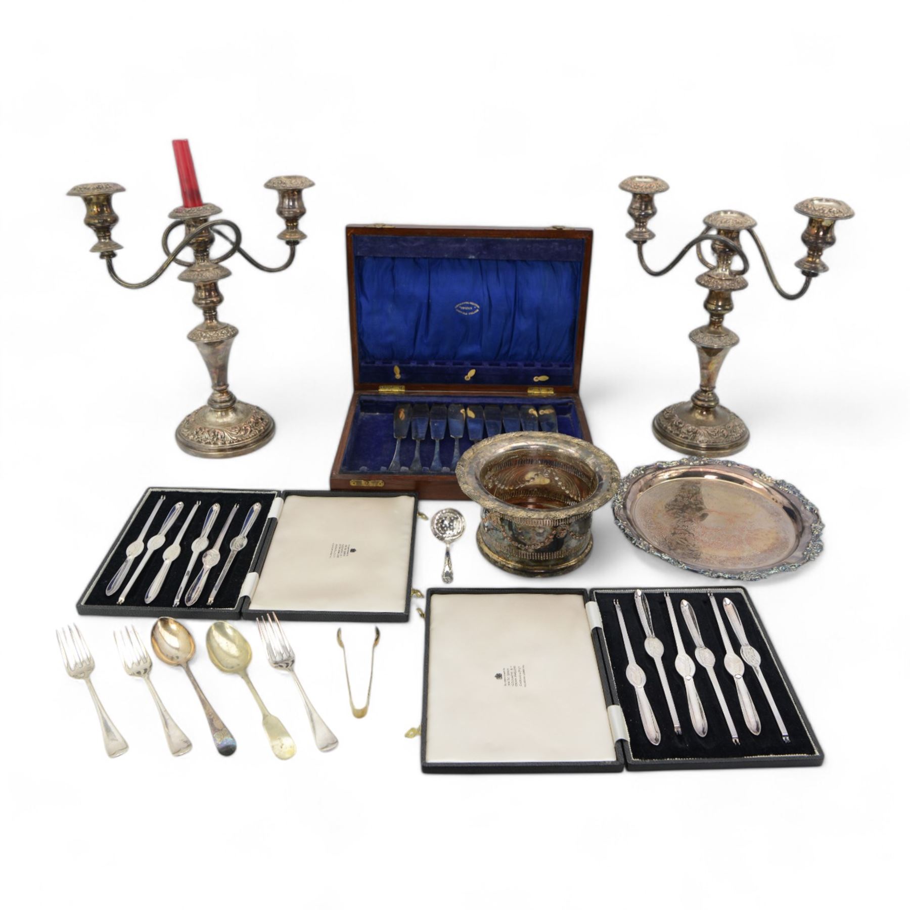 Two cases of six plated lobster picks by Garrards, pair of plated three light candelabra, Victorian plated coaster, plated salver and assorted cutlery