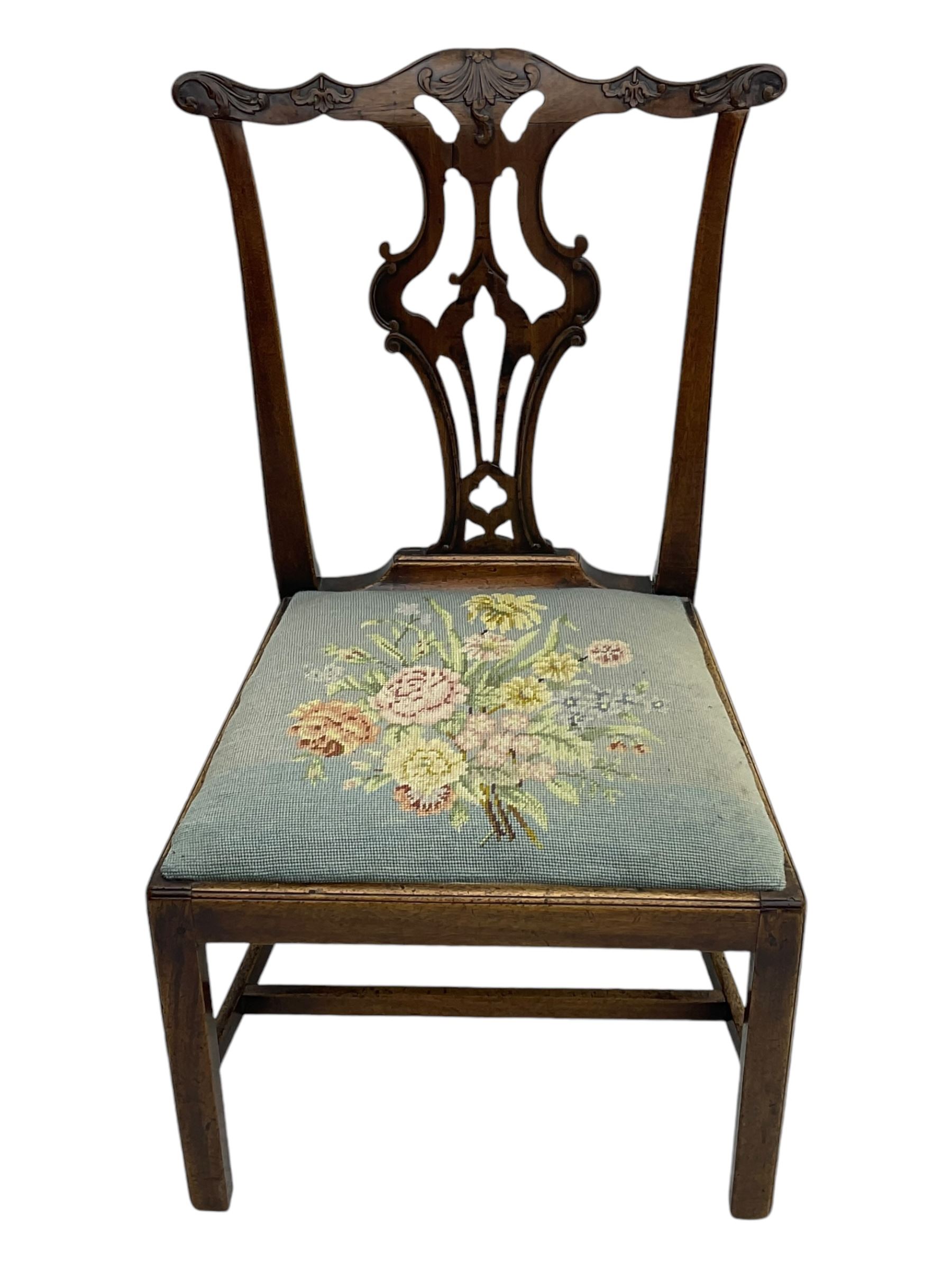 George III Chippendale design dining chair, shaped cresting rail carved with foliate scrolls over pierced and carved splat, floral needle-work upholstered drop-in seat, on square moulded supports united by H-stretchers 