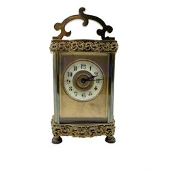 French - Edwardian 8-day carriage clock in a  Louis XV Doucine case, with overlaid friezes and gilt repousse work, gilt dial mask and enamel chapter with Arabic numerals, minute markers and spade hands, timepiece single train movement with original cylinder escapement. With key.
