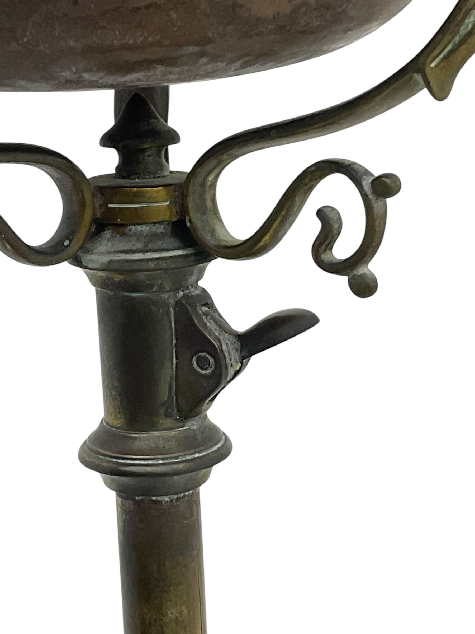 Victorian brass converted oil lamp stand, telescopic stem with scrolled uprights terminating to scrolled feet, dished base decorated with scrolling cast metal work and grotesque masks 