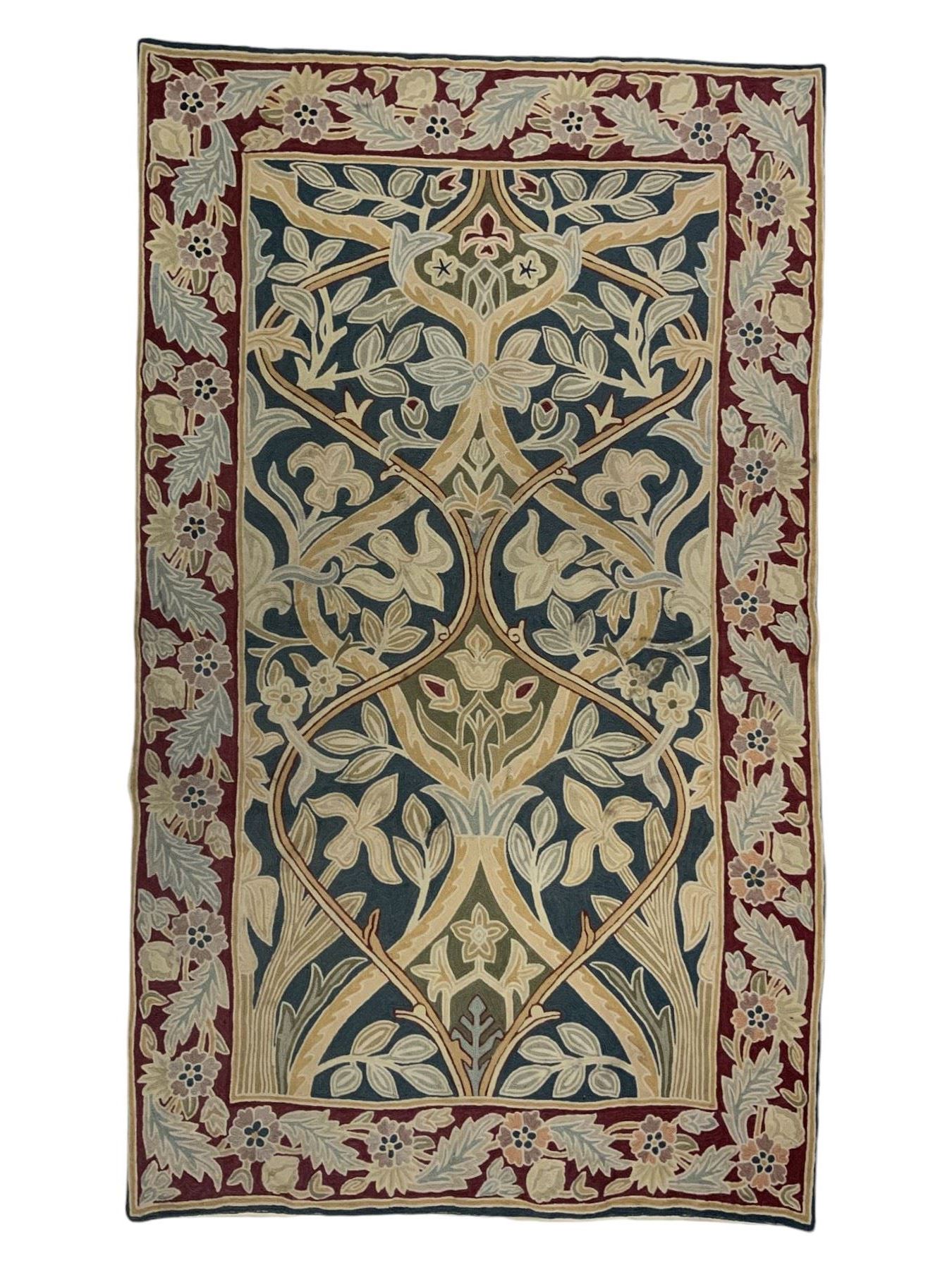 Caucasian design crewelwork hanging, the field decorated with a stylised tree of life motifs with surrounding leafage, enclosed by a crimson ground border with foliate designs