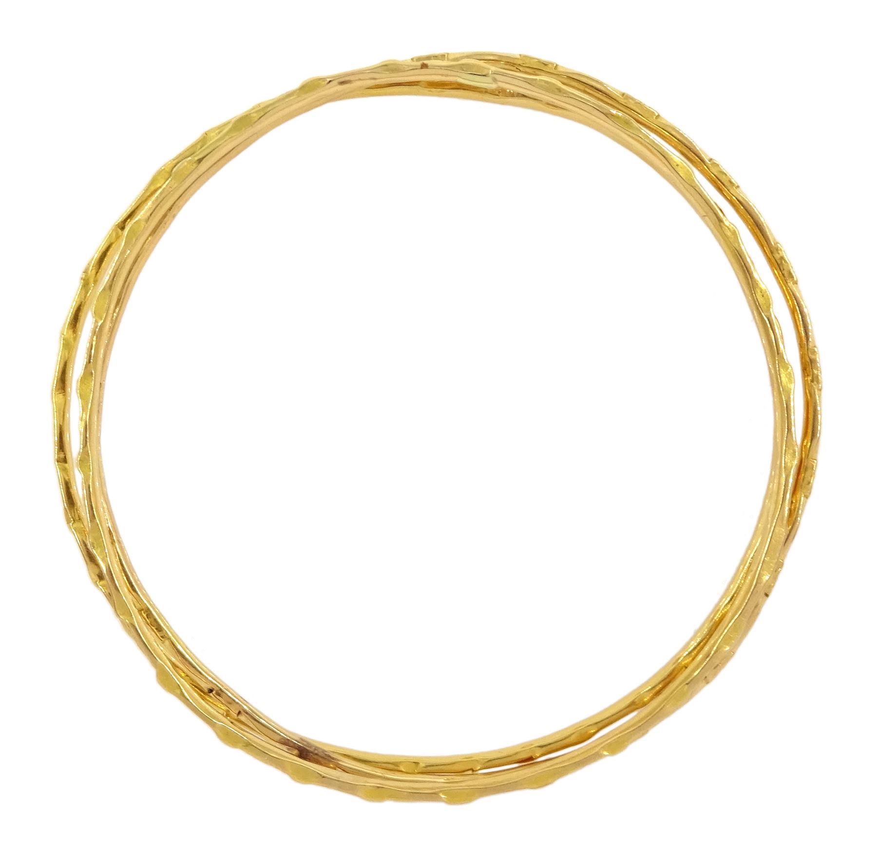 20ct gold Middle Eastern bangle and two similar 19.5ct gold bangles