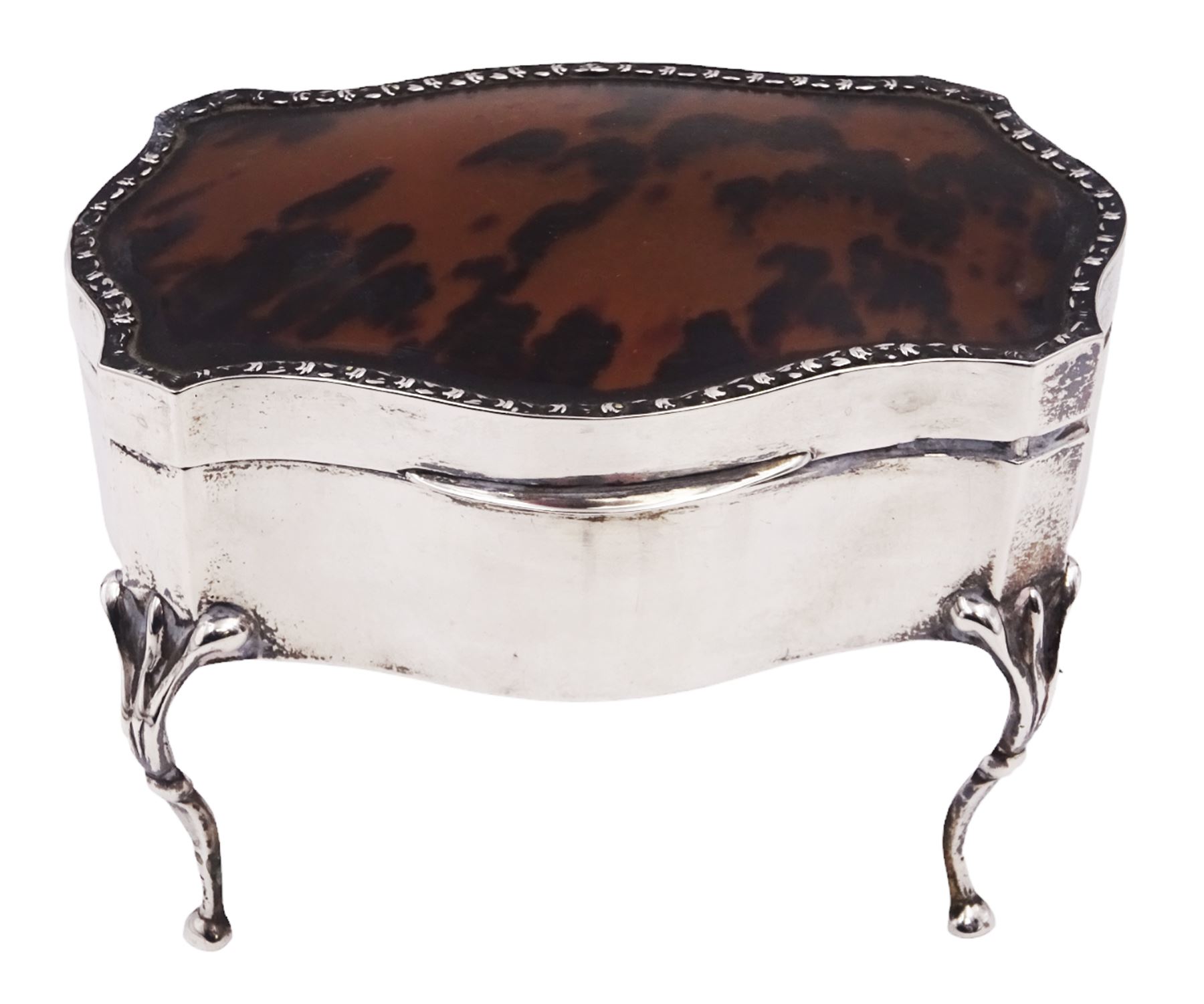 Early 20th century silver mounted jewellery casket, the slightly domed hinged cover set with a tortoiseshell panel, with a embossed floral border, opening to reveal a pleated silk lined interior, upon four cabriole legs, hallmarked Charles Boyton & Son Ltd, London 1913, H10cm