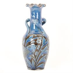 Alexander Lauder for Barum Pottery, vase of baluster form with fluted time, decorated in relief with fish upon a blue ground, H20cm