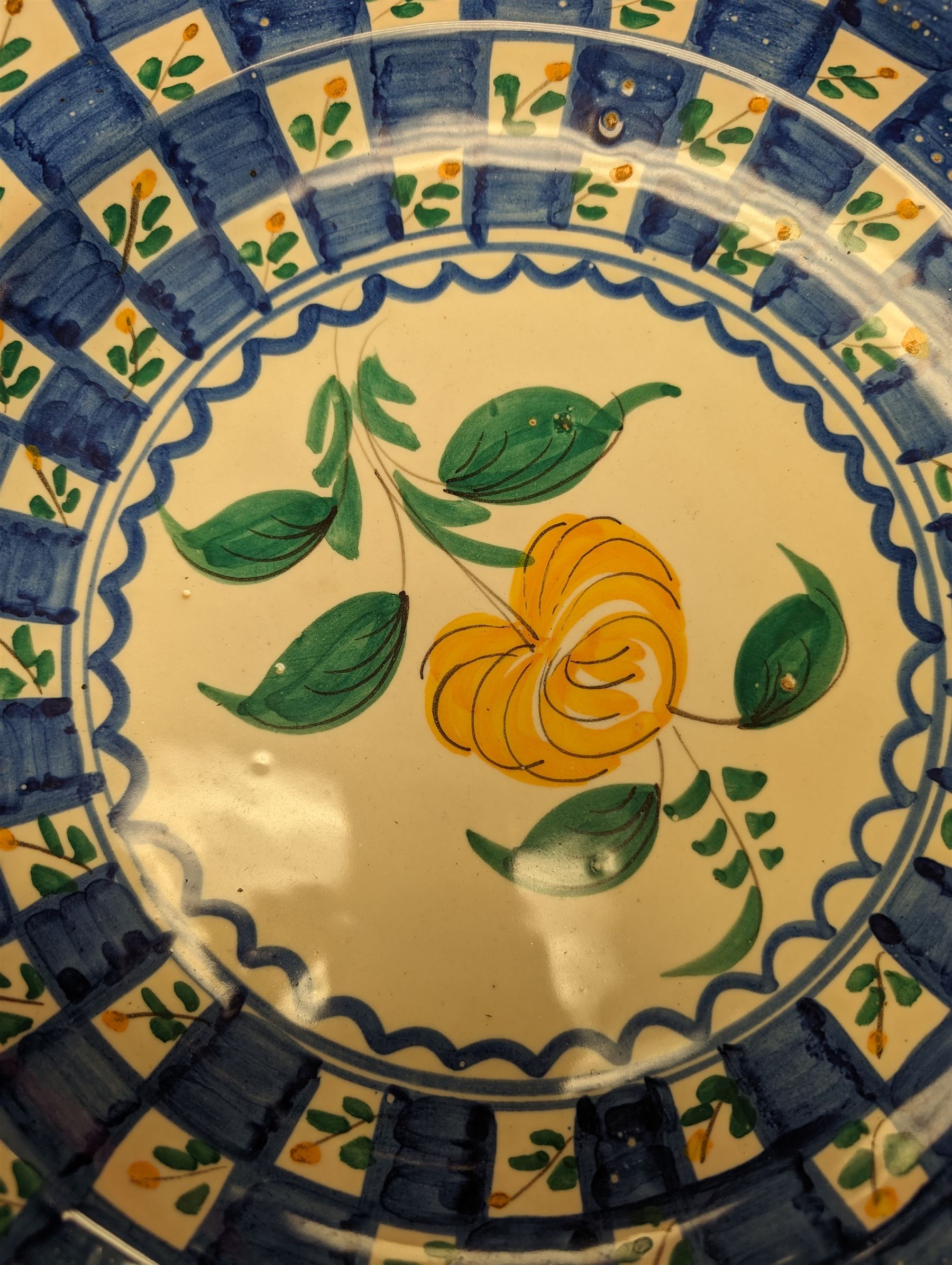 Six Spanish ceramic chargers, painted with bright floral patterns, three marked Lario, largest D35cm