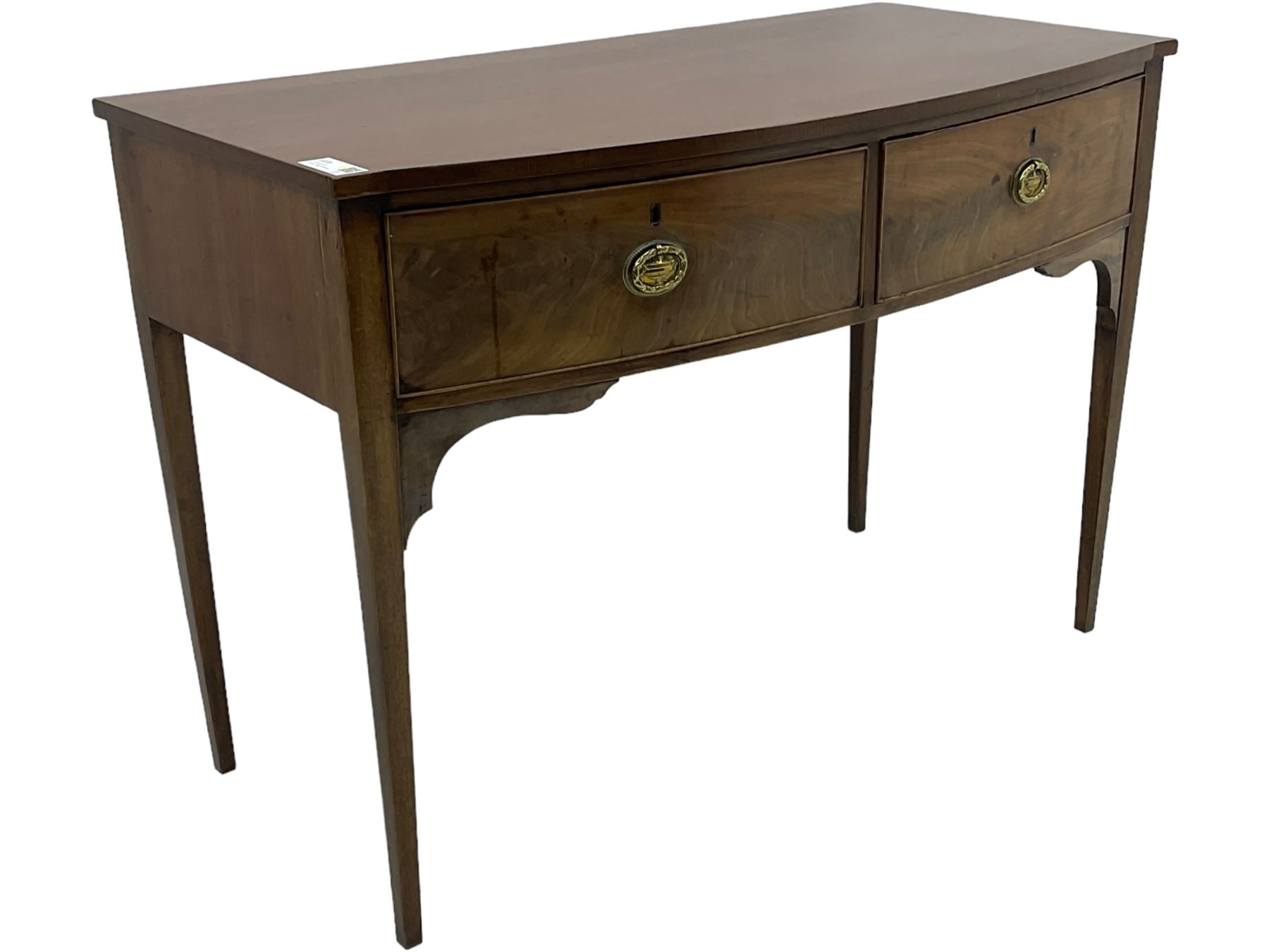 19th century mahogany bow-front serving table, fitted with two cock-beaded drawers with oval pressed brass handles decorated with urns, on square tapering supports 