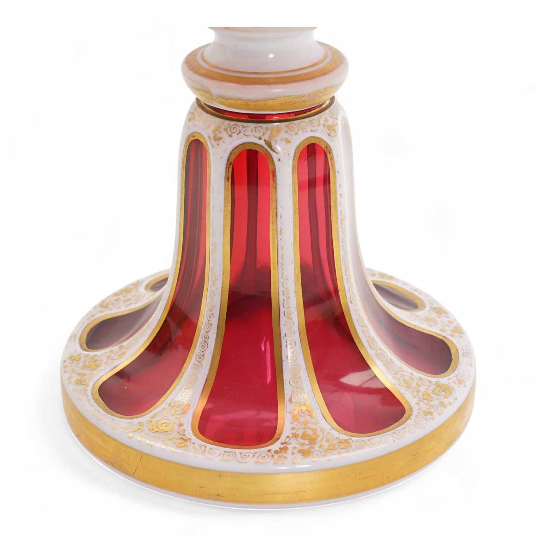 Late 19th century Bohemian white overlaid cranberry glass pedestal bowl, with fancy scalloped rim and cut with oval and fleur de lis shaped panels, each enamelled with 'Reynard the Fox' anthropomorphic animals, after the illustrations by Wiilhem Von Kaulbach,  within gold borders with gilt scrolling decoration, supported by a slice cut circular spreading foot with further gilt decoration, H28.5cm x W22.5cm