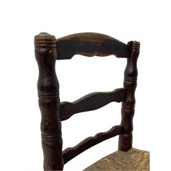 19th century painted elm primitive fire side chair, ladder back over rush seat, on turned supports united by turned stretchers 