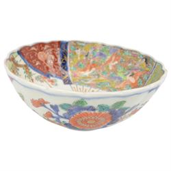 19th century/ early 20th century Chinese Canton blue and white bowl, centrally decorated with a landscape scene, within a famille rose enamelled border and scalloped rim, D26cm together with a Japanese Meiji Imari fluted bowl, decorated cranes, fans and scholar, D24cm (2)