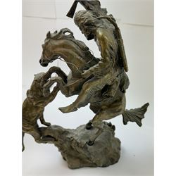 After Charles Marion Russell; Bronzed sculpture depicting man on horseback fighting a mountain lion, H42cm