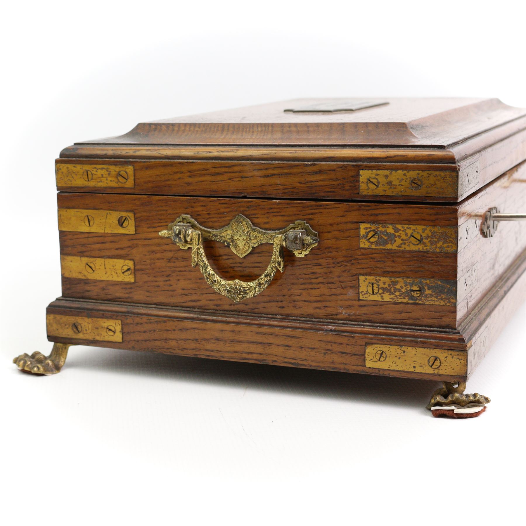 Victorian oak brass bound masonic casket, the cover with plaque engraved 'Morecombe Lodge, No. 1119, 1.0.0. M.U', on four brass lion paw supports, L40cm, H17cm, D30cm