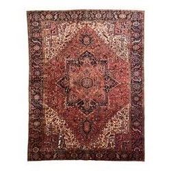 Persian Heriz red ground carpet, large stylised pole medallion surrounded by Pitrak motifs...