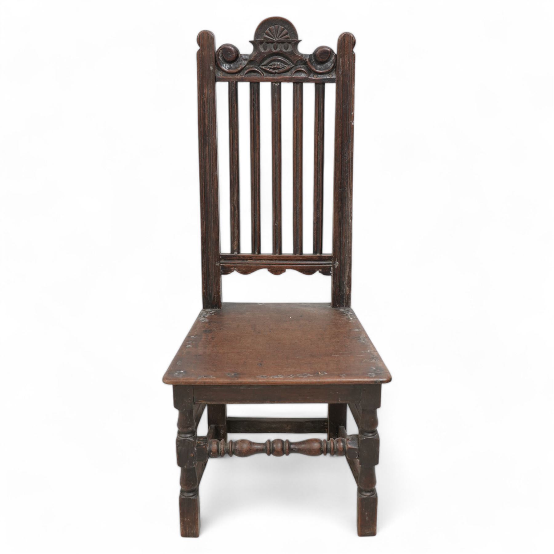 Mixed set of four 18th century oak side chairs, each with scroll carved pediment over vertical slat back, plank seat over turned and block supports