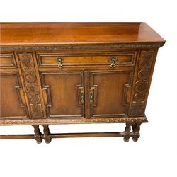 Early 20th century oak sideboard, raised panelled back with foliate carved decoration, rectangular top with gadrooned edge, fitted with two drawers over cupboards with field moulded facias, turned supports joined by stretchers