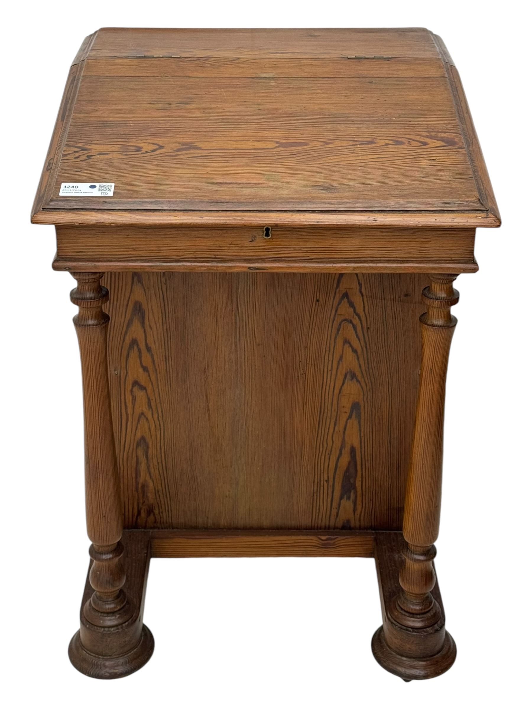 19th century pitch pine Davenport desk, sloping hinged top, fitted with four drawers, on turned column supports, turned compressed feet with castors 