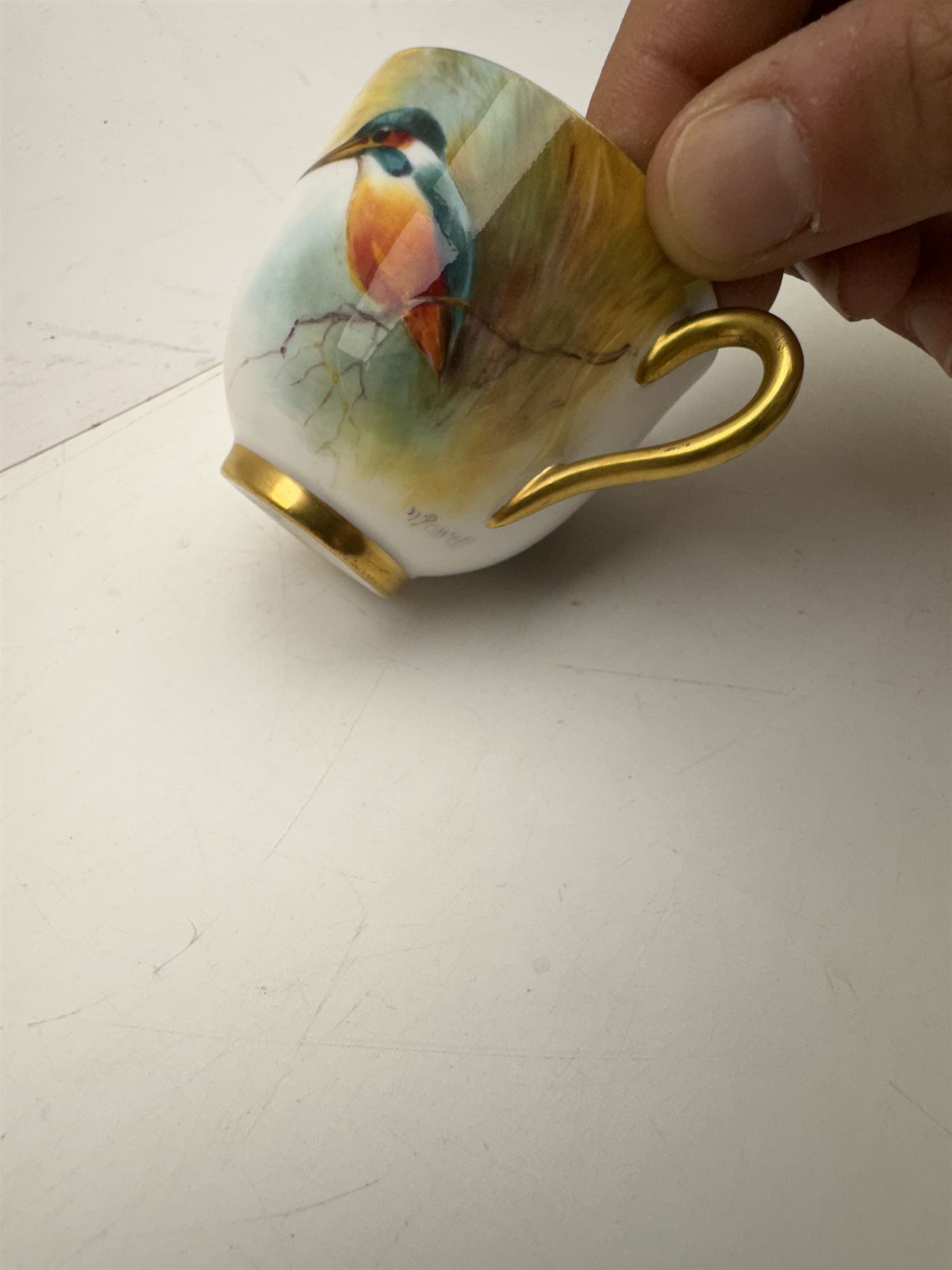 Royal Worcester cabinet cup, decorated with a kingfisher upon a branch by H. Powell, artist signed, together with matching saucer by other artist