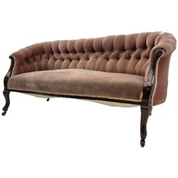 Late 19th century mahogany framed two-seat sofa, upholstered in buttoned pink fabric, on cabriole front supports, on castors 