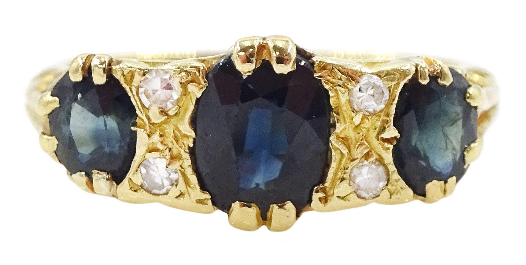 18ct gold three stone oval cut sapphire and four stone round brilliant cut diamond ring, stamped