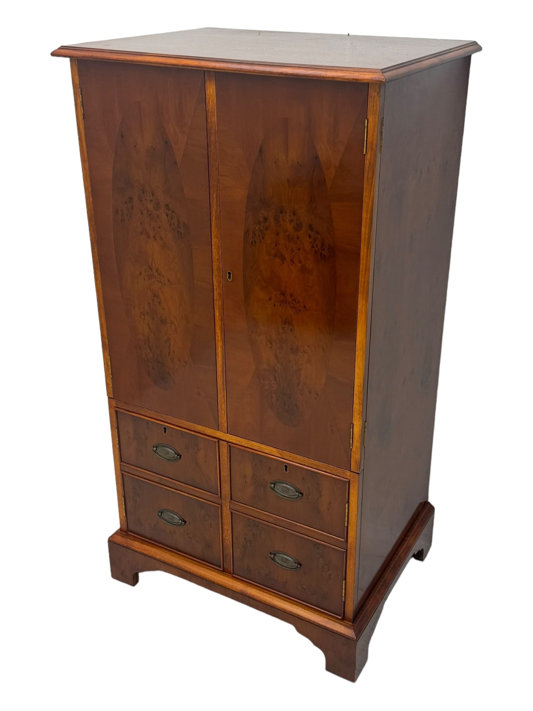 Wade - yew wood hi-fi cabinet, moulded rectangular hinged top over double-door cupboard with figured veneer, enclosing three adjustable shelves, lower section fitted with two cupboards to resemble four drawers, enclosing three drawers and open storage