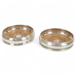 Pair of modern silver mounted bottle coasters, of typical circular form, with turned woode...