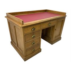 20th century oak desk, moulded rectangular top with raised back and inset leather writing surface, fitted with five drawers and single panelled cupboard, on moulded plinth base