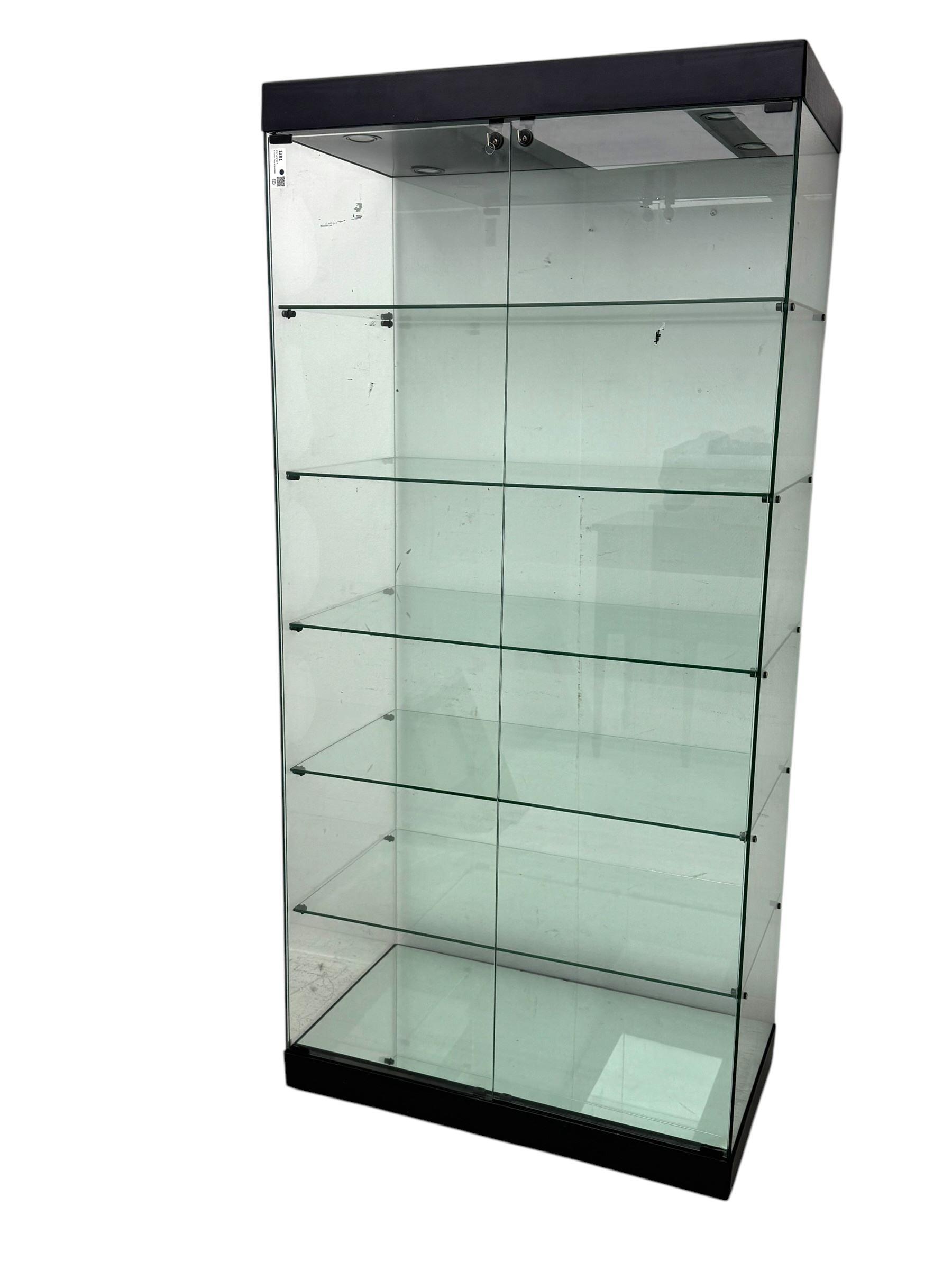 Glazed shop display cabinet fitted with two doors, six shelves with illuminated interior