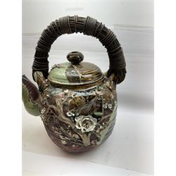 Very large Japanese Shigakari type coil built teapot, the body with a blossoming encrusted tree, woven loop handle and part green glazed spout and cover, H52cm