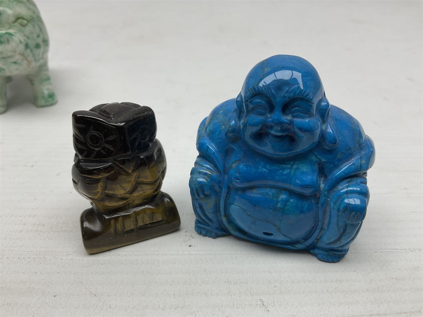 Carved Lapis lazuli figure in the form of Ganesha, together with turquoise carved buddha, tigers eye owl and other carved figures and plaques, Ganesha 8cm