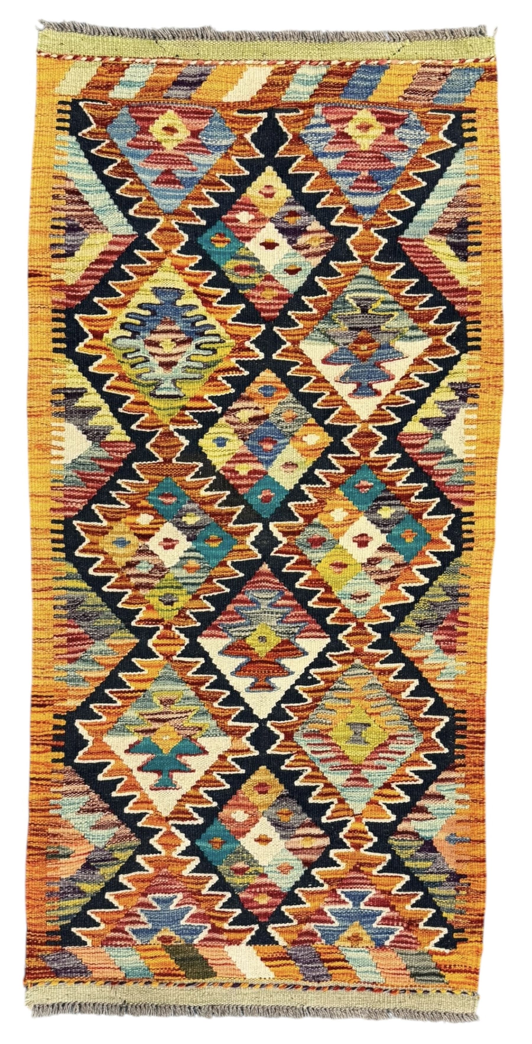 Chobi Kilim multicoloured ground runner, displaying diamond-shaped motifs in shades of blue, red, yellow, and green, accented by a bold black outline and bordered with a striped design, flatwoven with fringed edges