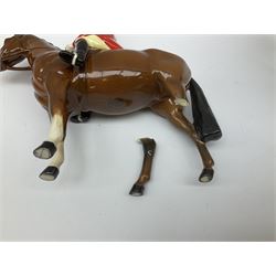 Beswick Hunting Group, comprising: two huntswoman on grey horses, model no 1730, huntsman on a bay horse, model no 1501, a seated fox, model no 1748, eighteen fox hounds and a spaniel, model no 967, all with printed marks beneath, together with three other ceramic huntsman on horseback and two hounds. 