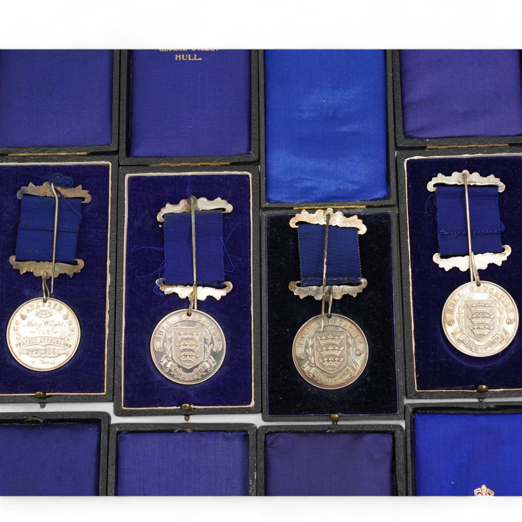 Eight Hull Education Committee 'Perfect Attendance At School' hallmarked silver medallions, each housed in a fitted case