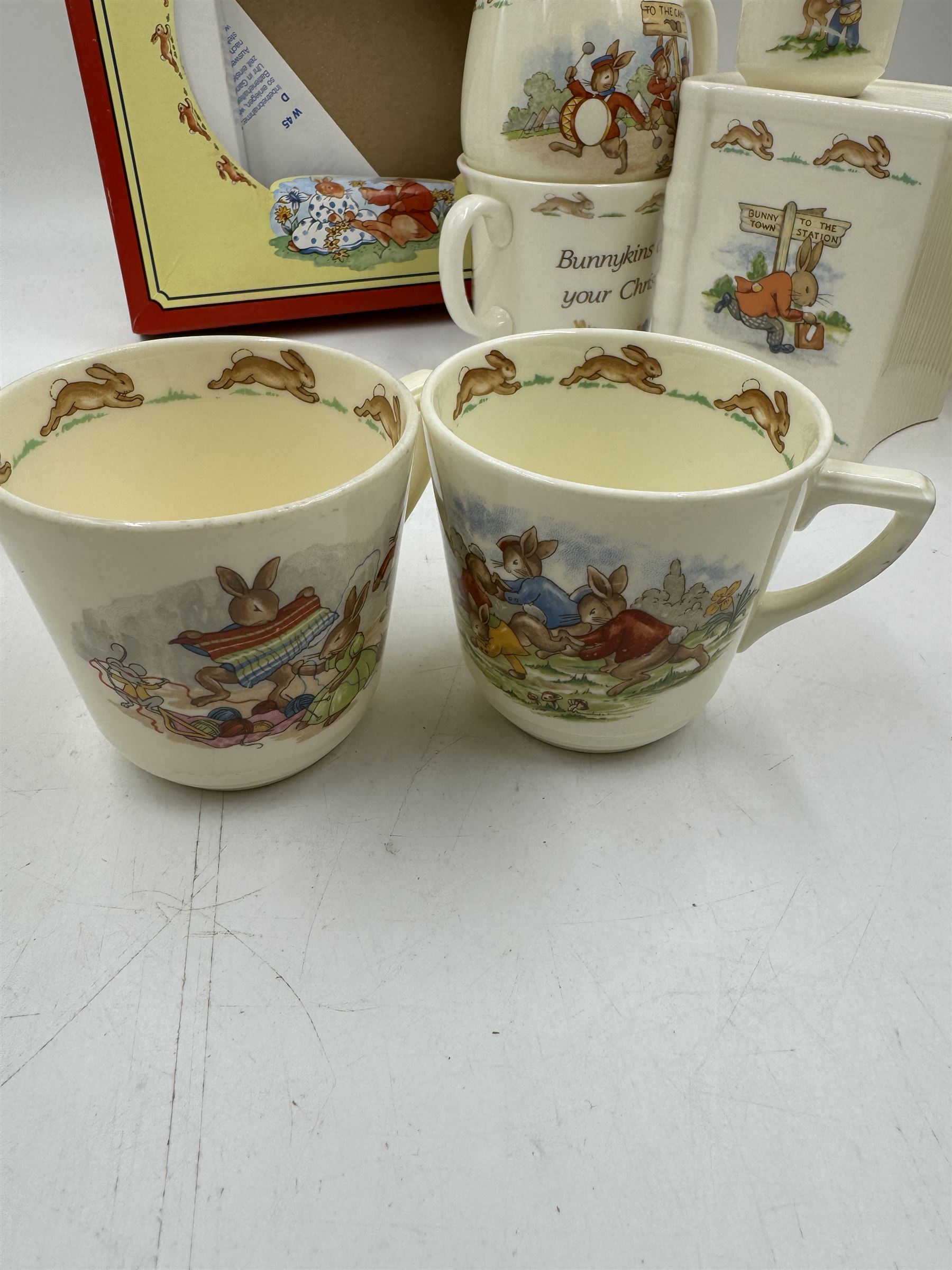 Royal Doulton Bunnykins teawares, including teacups and saucers, egg cup, money boxes etc (12)