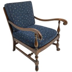 Early 20th century stained beech framed armchair, cane panel back over scrolled arm terminals, raised on turned supports united by turned H-stretcher, with patterned blue upholstered loose back and seat cushions