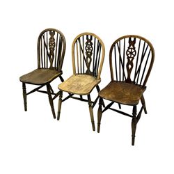 Mid-to-late 20th century set of six elm and beech Windsor dining chairs, hoop and stick back with pierced wheel splat, dished elm seat, on turned supports united by turned stretchers 