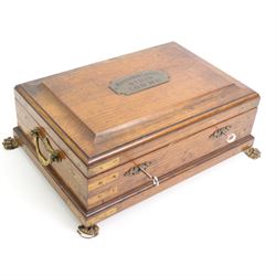 Victorian oak brass bound masonic casket, the cover with plaque engraved 'Morecombe Lodge, No. 1119, 1.0.0. M.U', on four brass lion paw supports, L40cm, H17cm, D30cm