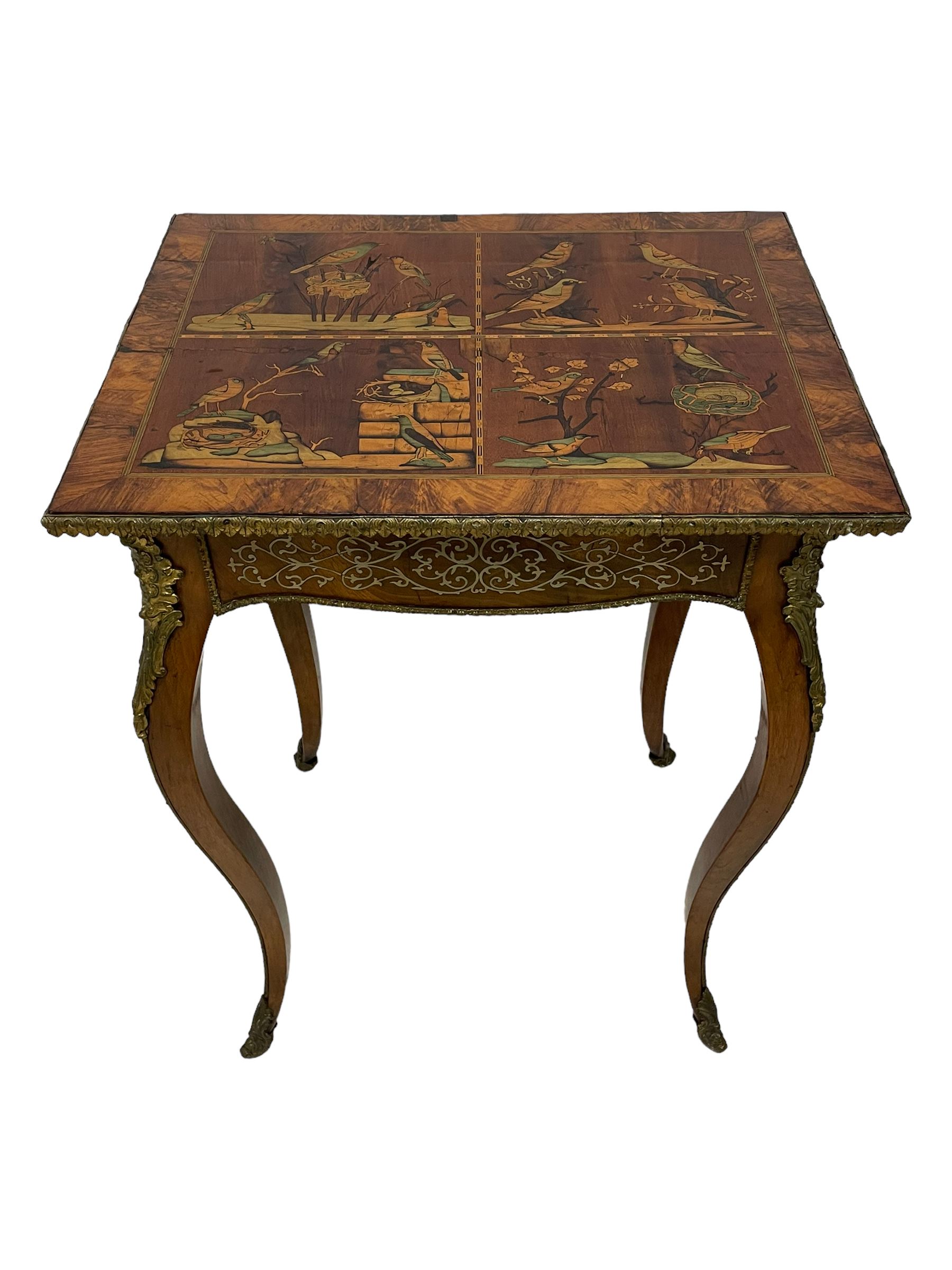 In the manner of Émile Gallé - late 19th to early 20th century inlaid walnut side table, rectangular top inlaid with Japonisme decoration depicting birds within trees, figured crossbanding and cast gilt foliate applied edge, single frieze drawer inlaid with scrolling brass work, on cabriole supports with ornate floral mounts