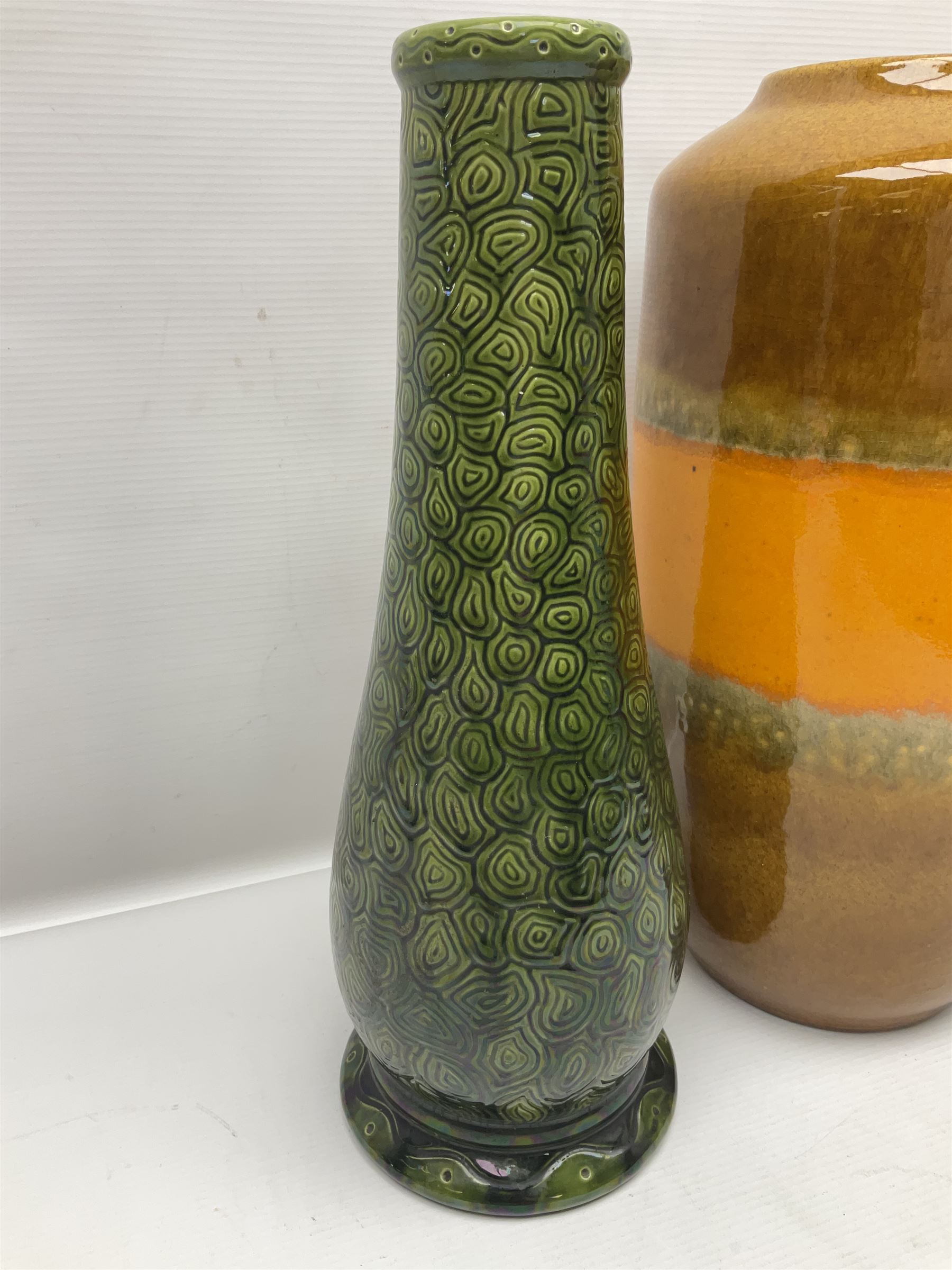 Burmantofts Faience vase, with elongated neck, and concentric circle decoration, in a green lustre glaze, together with a Bretby figure, modelled as a cat with a ball of wool, a Bretby vase, with fluted rim, in orange/red glaze, frog jug and a large West German vase, tallest H38cm