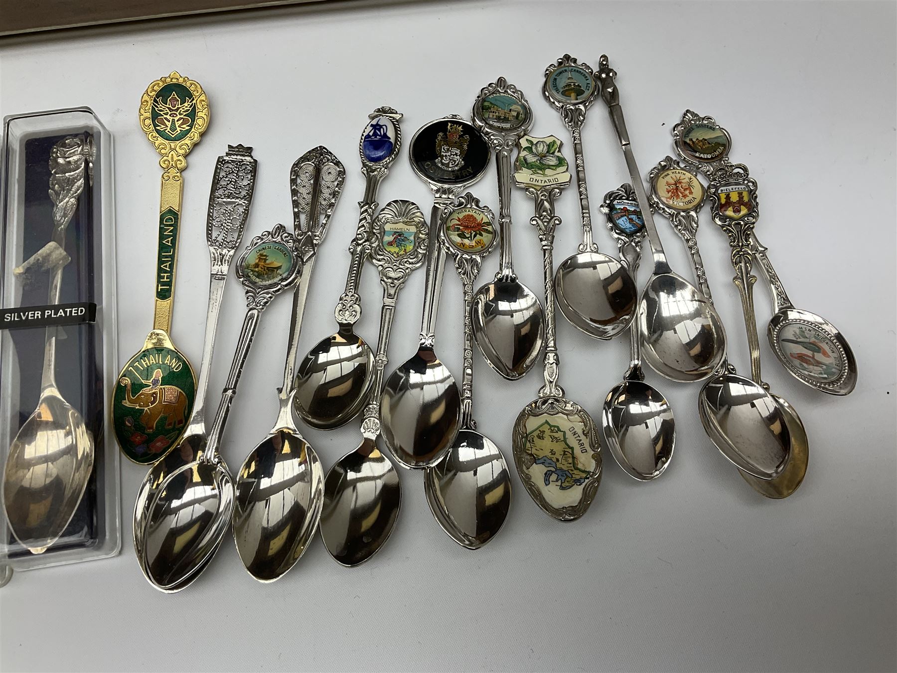 Collection of souvenir teaspoons with wooden display case, H62cm, L53cm. 