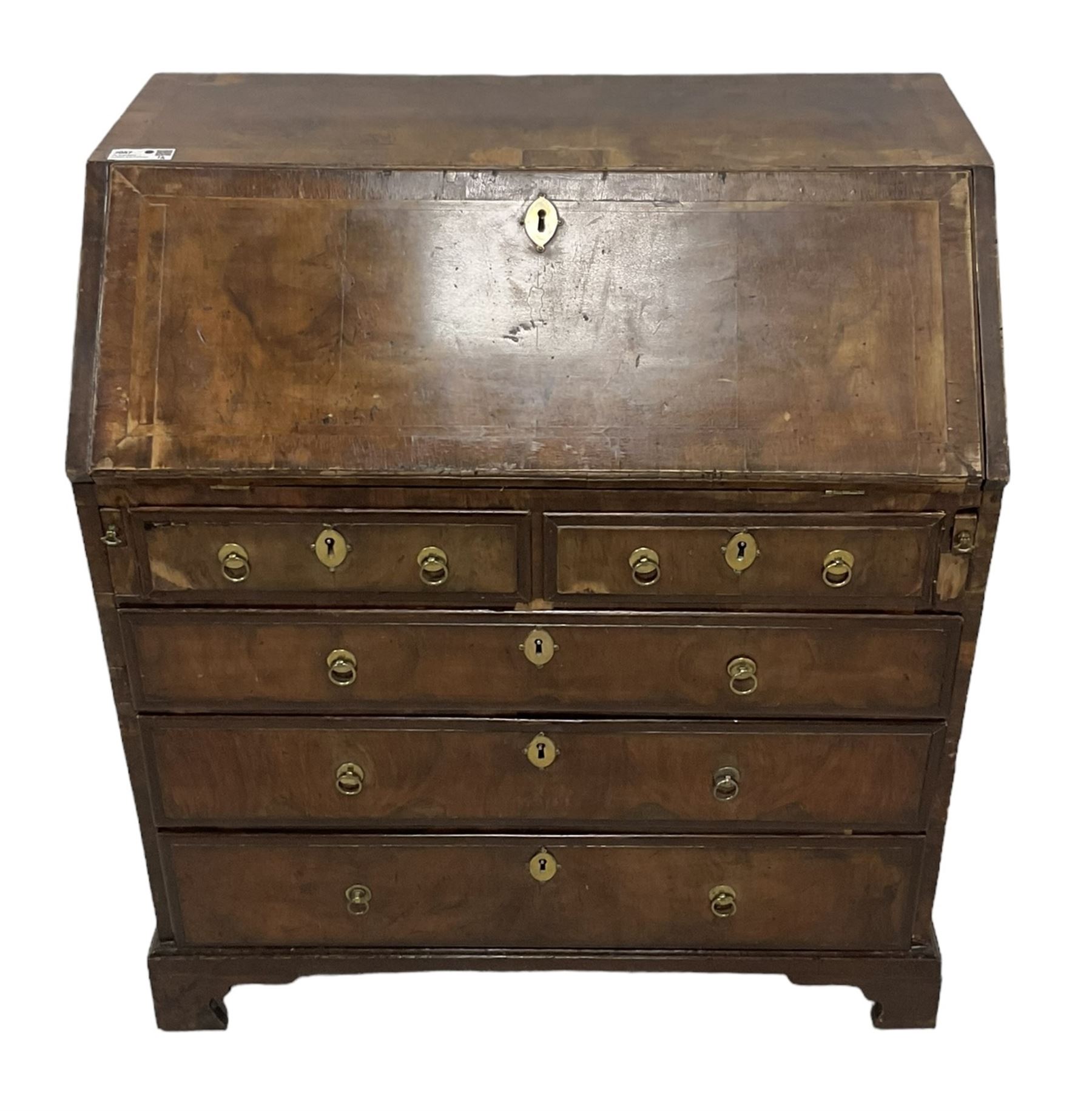 18th century walnut bureau, crossbanded and feather-banded rectangular top and fall-front, enclosing fitted interior with pigeonholes and correspondence drawers with bone handles, over two short and three long graduating drawers with moulded facias and original brass handles, on bracket feet