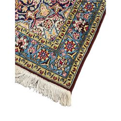 Persian indigo ground rug, overall arabesque design, central multi-point medallion surrounded by scrolling leafy branches and palmettes, the border decorated with repeating stylised plant motifs within guard stripes 