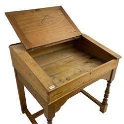 Early 20th century pitch pine clerk’s desk, stripped mahogany sloped hinged top, raised on turned supports