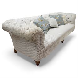 Victorian oak framed three seat Chesterfield sofa, traditional shape, upholstered in deep buttoned ivory and blue patterned fabric, raised on turned feet, with loose scatter cushions