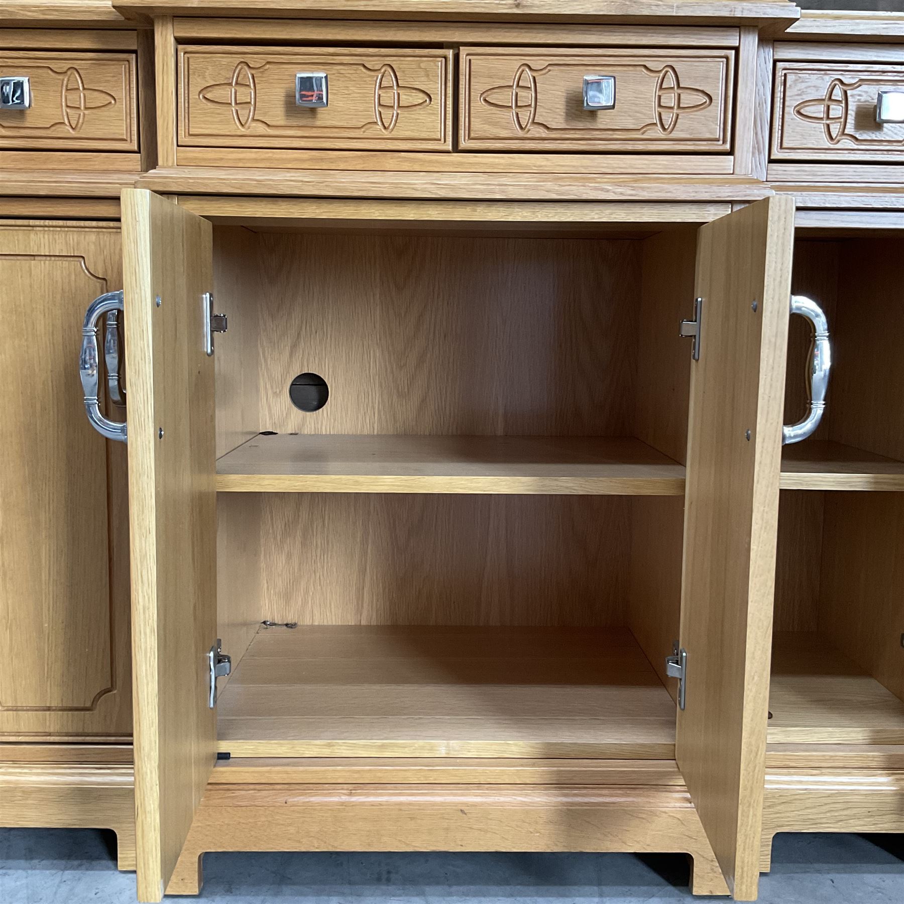 Light oak breakfront sideboard dresser, fitted with four drawers and four cupboards