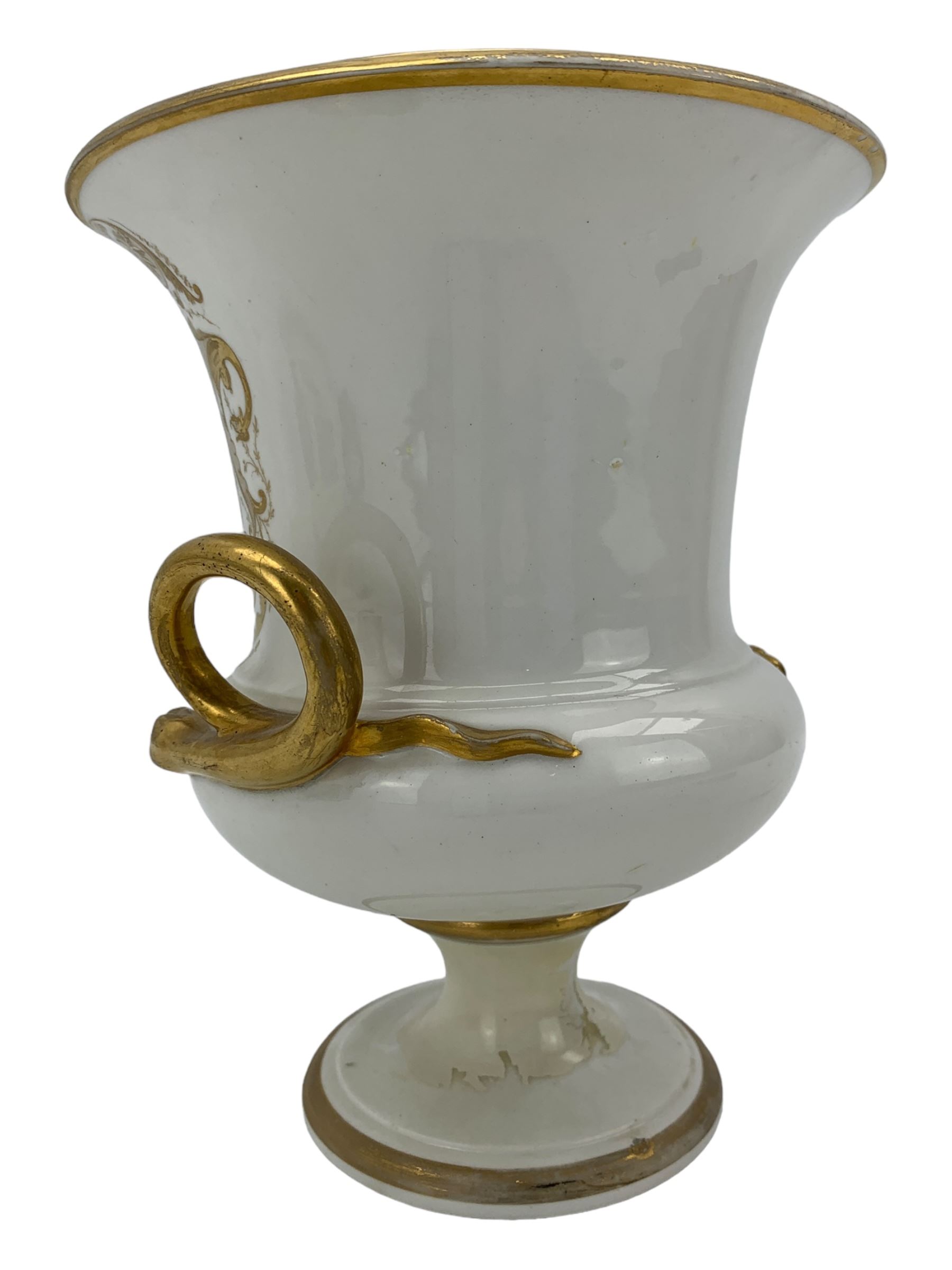 Early 19th century Derby vase, of campana urn form, decorated to one side with a hand painted reserve of a basket of flowers, within a scroll gilt border and twin serpent form handles, H20.5cm together with a Bloor Derby vase, hand painted with figures in a wooded landscape, with twin gilt swan form handles, upon a square pedestal foot, H25cm (2)