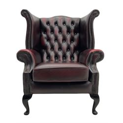 Georgian style wing back armchair, upholstered in oxblood buttoned leather